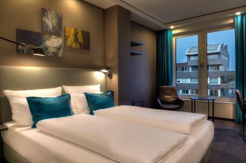 Katil atau katil-katil dalam bilik di Motel One Amsterdam-Waterlooplein