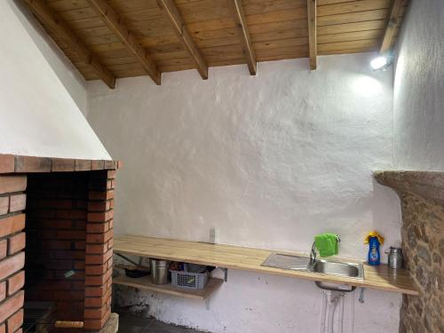 a kitchen with a sink and a counter top at Casa Erundina in Camariñas