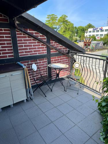 a balcony with a table and a brick building at 2 pokojowy apartament in Dąbki