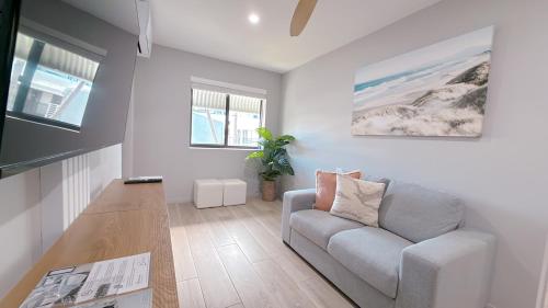 a living room with a couch and a table at Belmoral Corporate Suites in Townsville