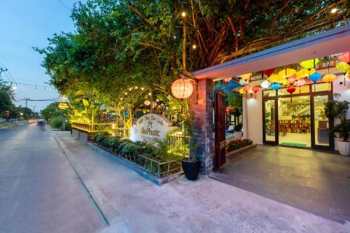 a store front with lights on a city street at Blessing Villa Hoi An in Hoi An