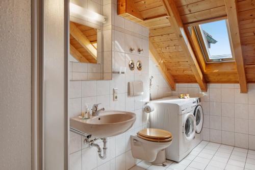 a bathroom with a toilet and a sink at Fewo Cheny mit Hochschwarzwaldcard in Titisee-Neustadt