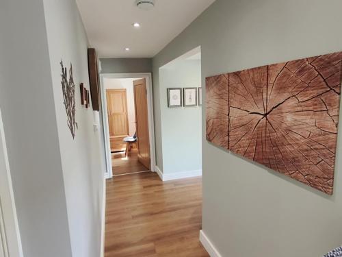 a hallway with a large wall art on the wall at Littleton Farm Barns in Saham Toney