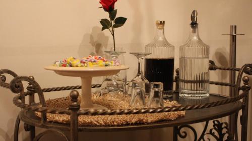 a table with a plate of food and wine bottles at Constantin in Dhémbla