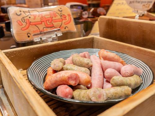 a plate of hot dogs and sausages in a box at Hotel Art Stay Naha Kokusai-Dori in Naha