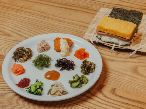 a plate of food with vegetables and a sandwich at Hotel Art Stay Naha Kokusai-Dori in Naha