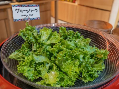 a bowl of lettuce sitting on top of a table at Hotel Art Stay Naha Kokusai-Dori in Naha