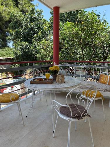 a table and chairs on top of a patio at Sunbeam house in Nea Makri