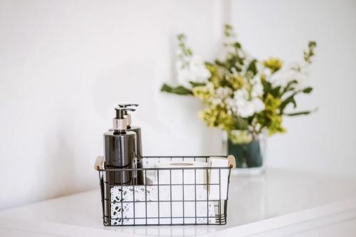 a basket sitting on a counter with a vase of flowers at Leygreen Farmhouse B&B in Beaulieu