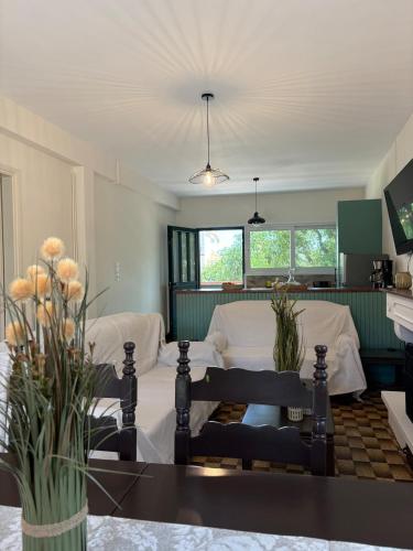 a living room with a couch and a table at Sunbeam house in Nea Makri