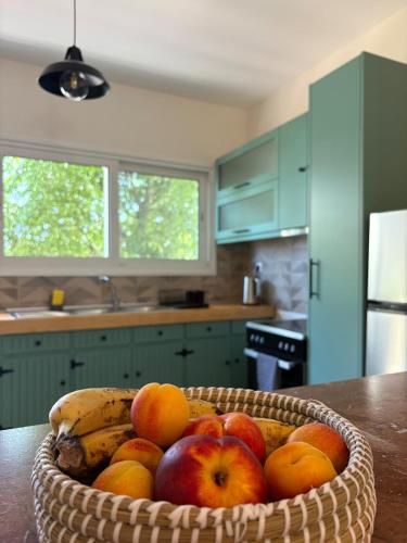 a basket of fruit on a table in a kitchen at Sunbeam house in Nea Makri