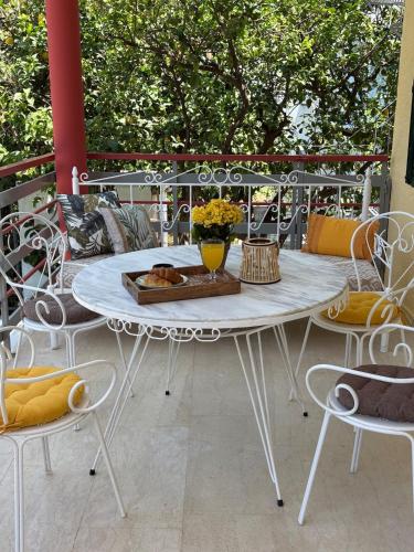 a white table and chairs on a patio at Sunbeam house in Nea Makri