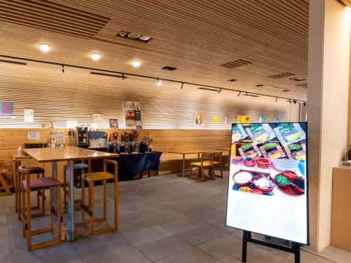 a restaurant with tables and chairs and a sign at Hotel Art Stay Naha Kokusai-Dori in Naha
