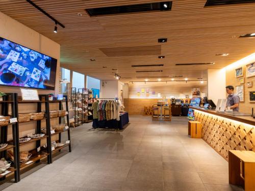 a store interior with a man standing at a counter in a store at Hotel Art Stay Naha Kokusai-Dori in Naha