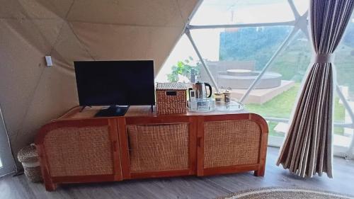 a tv on top of a table in a tent at Mahkota Sangkuriang Bandung in Bandung