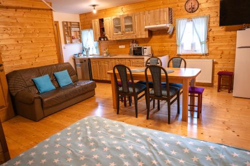 a kitchen and living room with a table and chairs at Chata Říp II 