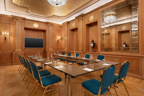 a conference room with a long table and chairs at The Westin Palace, Milan in Milan
