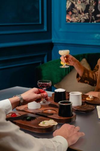 two people sitting at a table with glasses of wine at The Westin Palace, Milan in Milan