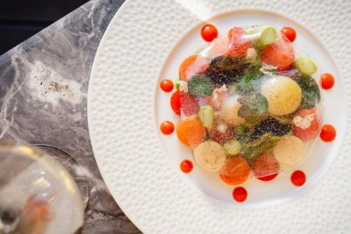 a plate of fruit and vegetables on a table at The Westin Palace, Milan in Milan