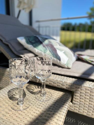 two wine glasses sitting on top of a table at Moderne Ferienwohnung Nähe Bad Griesbach, Haarbach in Haarbach