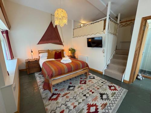 a bedroom with a bed and a staircase in it at Zion Place in Dartmouth