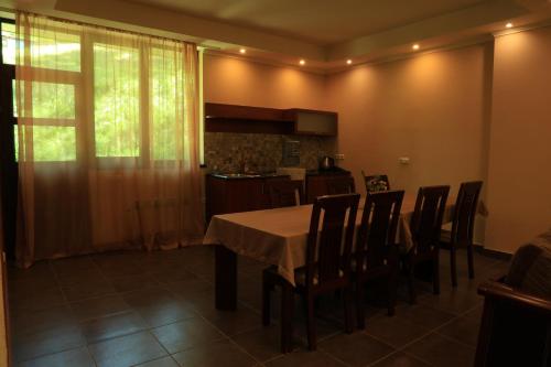 a kitchen and dining room with a table and chairs at Dilijan Park Resort & Villas in Dilijan