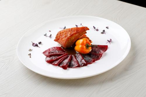 a white plate of food on a table at MICHELINO 75 by the Sydney Hotel in Bologna