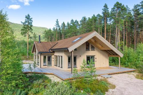 a small house in the middle of a forest at Det Kosekroken – Nordic Style Holiday Home by the Fjord in Vradal