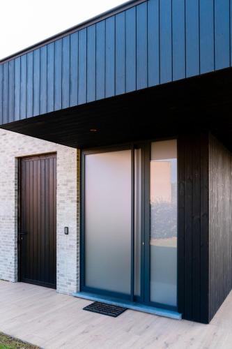 a building with two large glass doors on it at VAKANTIEDOMEIN DOUVE in Heuvelland