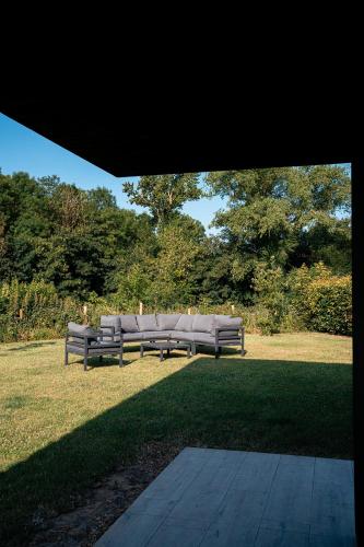 a row of park benches sitting in the grass at VAKANTIEDOMEIN DOUVE in Heuvelland