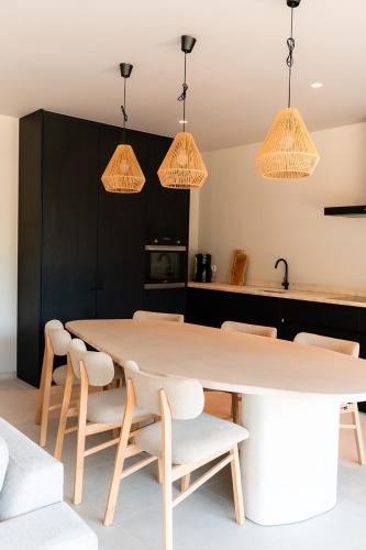 a kitchen with a large wooden table and chairs at VAKANTIEDOMEIN DOUVE in Heuvelland