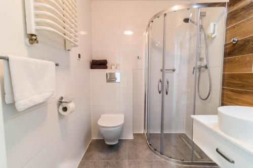 a bathroom with a shower and a toilet and a sink at Hotel Nafta Krosno in Krosno