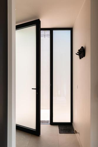 two glass doors in a room with white walls at VAKANTIEDOMEIN DOUVE in Heuvelland