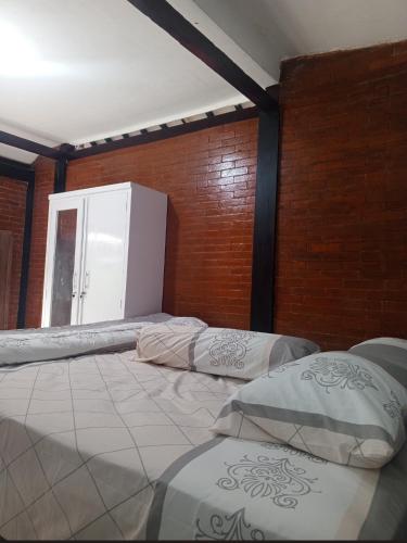 Postel nebo postele na pokoji v ubytování Homestay Aditya