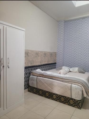 Postel nebo postele na pokoji v ubytování Homestay Aditya