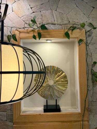 a fan is on a shelf in a mirror at Vastu Boutique Hotel in Kathmandu