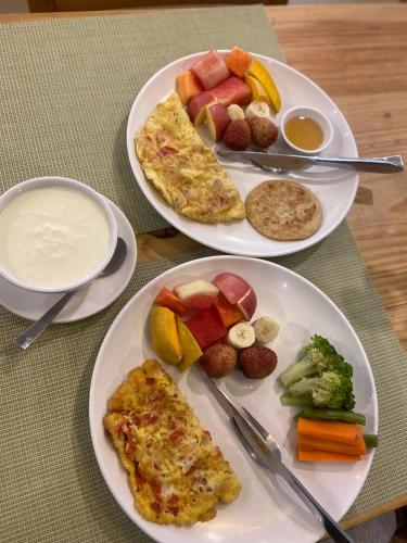 two plates of breakfast food on a table at Vastu Boutique Hotel in Kathmandu