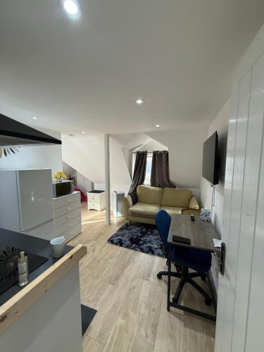 a living room with a table and a couch at A Lovely and Cosy Studio Apartment in Navestock