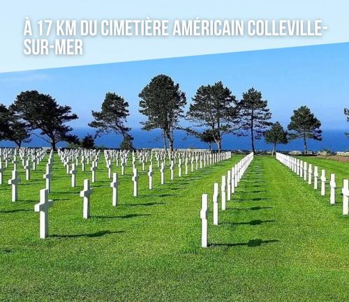 a row of white graves in a grass field at Les continents maison spacieuse 4 belles chambres parking privatif terrasse à 5 mn à pied tous commerces et 20 mn plage Omaha Beach et à 15 mn de Bayeux in Le Molay-Littry