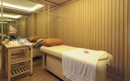 a spa room with two beds and a table at Vasaka The Reiz Condo in Medan