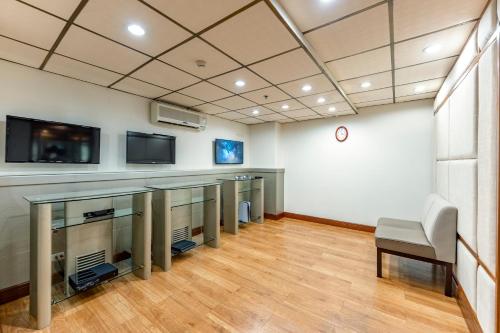 a room with a tv and a table and a chair at Sherwood Residence in Ho Chi Minh City