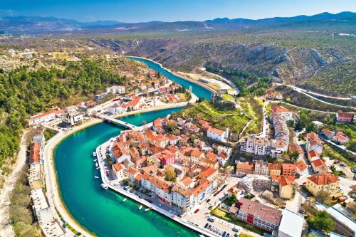 an aerial view of a town next to a river at Apartman Ivan in Kruševo