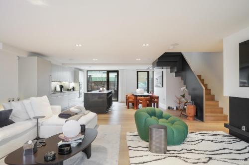 a living room with a white couch and a table at Mayfair Residences in London