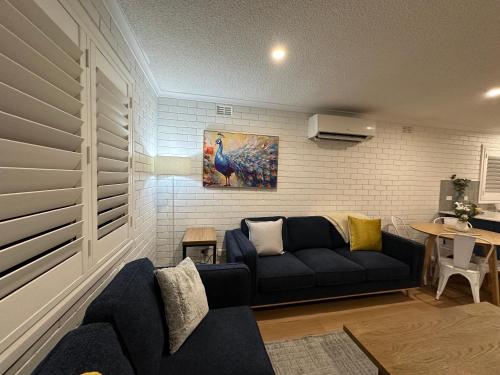 a living room with a couch and a table at Central Cullen Wagga Apartments in Wagga Wagga