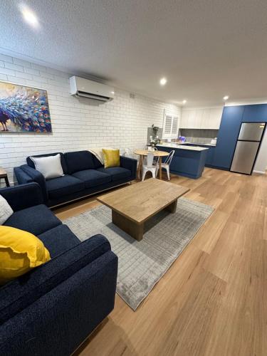 a living room with a couch and a coffee table at Central Cullen Wagga Apartments in Wagga Wagga