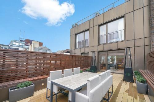 a patio with a table and chairs on a balcony at Mayfair Residences in London