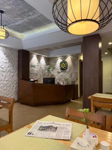 a lobby with a reception desk and a table at Vastu Boutique Hotel in Kathmandu