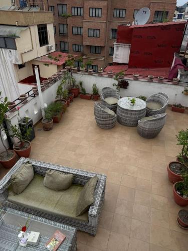 a balcony with a couch on a patio with plants at Vastu Boutique Hotel in Kathmandu