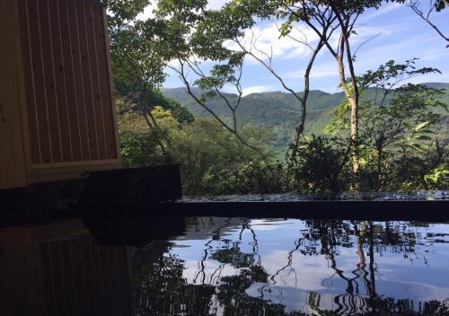 a pool with a view of the mountains at LiVEMAX Resort Atami Forest in Atami