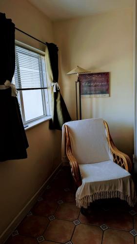 a chair sitting in a room with a window at Apartment Wexford Crescent Mall in Wexford